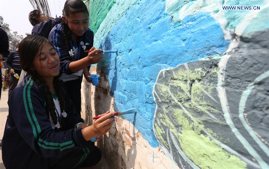 Girls draw on a wall during the 'Wall of Hope Campaign' in Kathmandu, Nepal, Feb. 17, 2017. 