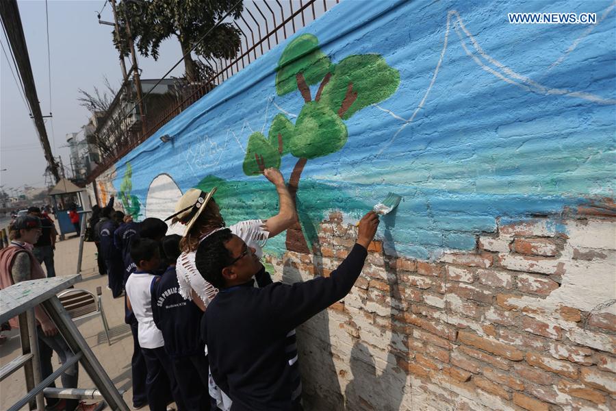 People draw on a wall during the 'Wall of Hope Campaign' in Kathmandu, Nepal, Feb. 17, 2017. 