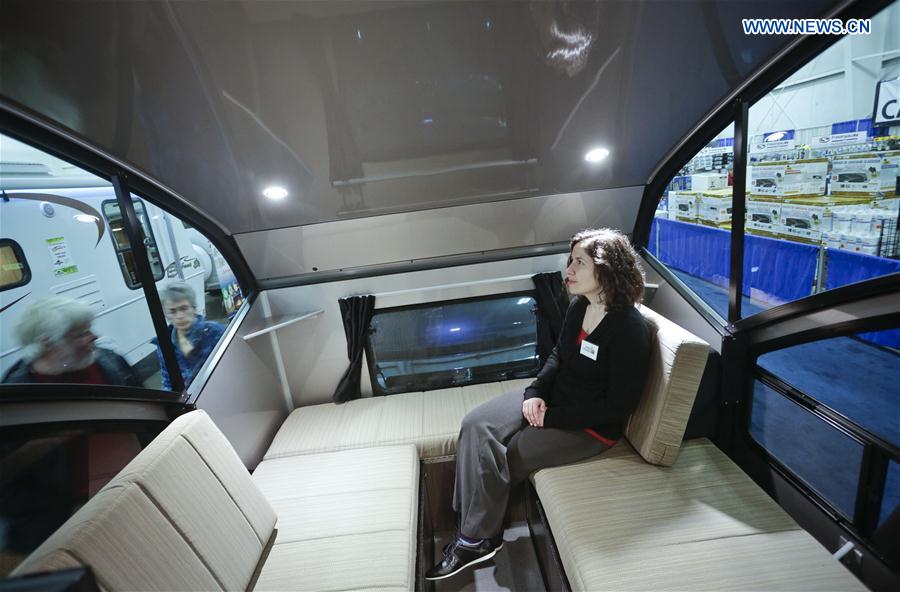 A woman sits in a recreation vehicle during the Earlybird RV Show in Vancouver, Canada, Feb. 17, 2017. 