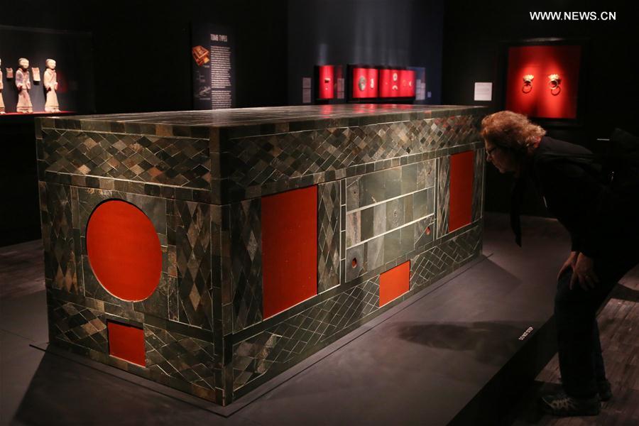 A visitor watches a coffin of the Han Dynasty during the exhibition 'Tomb Treasures: New Discoveries from China's Han Dynasty' at the Asian Art Museum in San Francisco, the United States, on Feb. 17, 2017.
