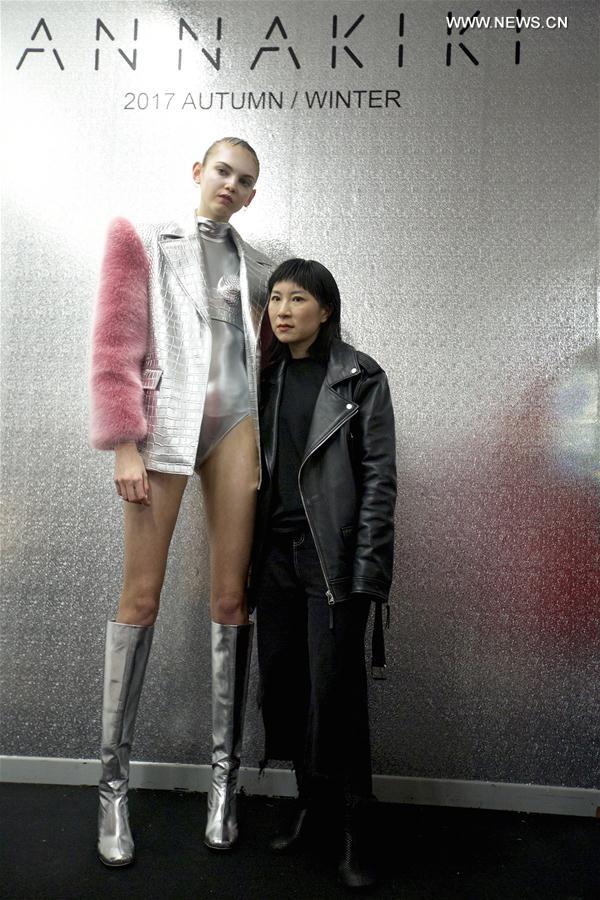 Chinese designer Yangzi (R) poses for a photo with her model backstage before ANNAKIKI show during Milan Fashion Week Fall-Winter 2017-18 in Milan, Italy on Feb. 22, 2017. Chinese designer Yangzi (R) poses for a photo with her model backstage before ANNAKIKI show during Milan Fashion Week Fall-Winter 2017-18 in Milan, Italy on Feb. 22, 2017.