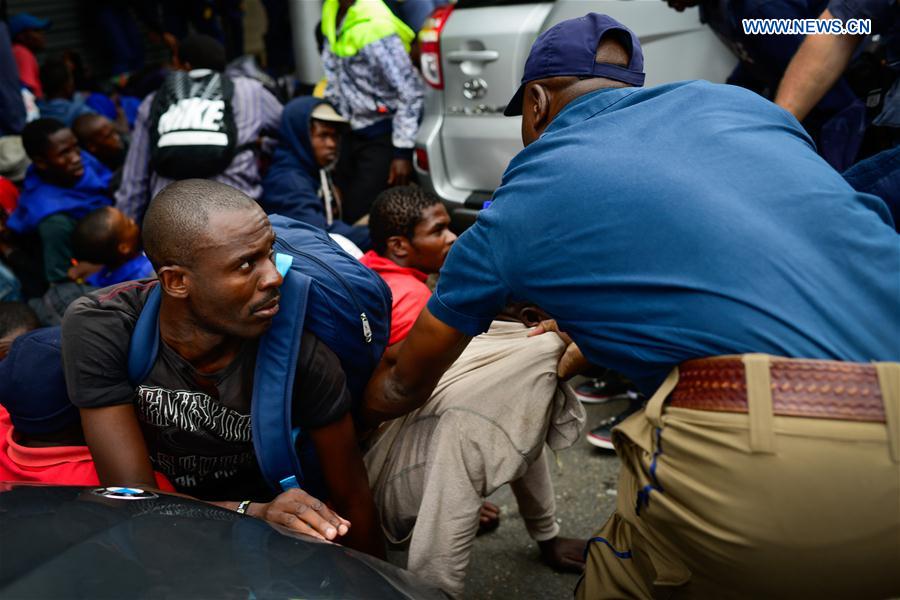 Policeman arrests an activist during an anti-immigrant march in Pretoria, South Africa, on Feb. 24, 2017.