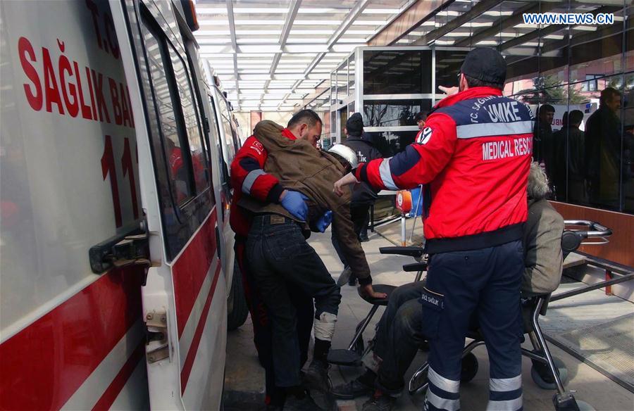 Medical workers transfer injured men in a suicide bombing near Syria's northern city of al-Bab to a hospital in Kilis, Turkey, on Feb. 24, 2017. 