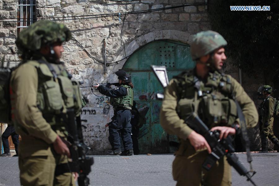 Israeli security forces stand guard during a protest demanding the opening of the Al-Shuhada Street which has been closed by Israeli authority for many years in the West Bank city of Hebron, on Feb. 24, 2017.