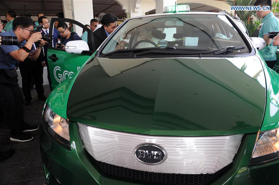 Singapore's Minister in Prime Minister's Office Chan Chun Sing (Seating in car) attends the launch of the HDT Electric Taxi held in Singapore on Feb. 24, 2017. 