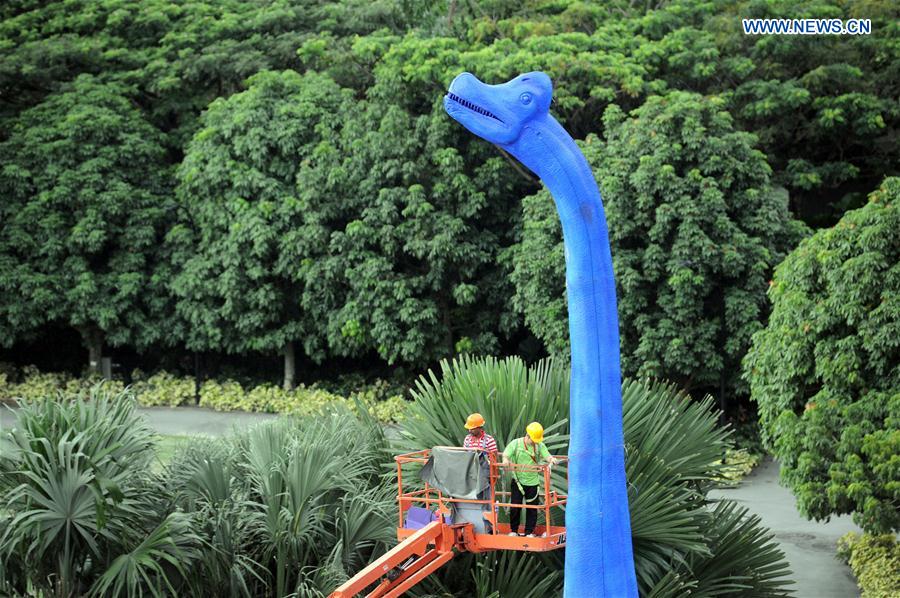 Workers install a dinosaur statue for the Children's Festival in the Supertree Grove at Singapore's Gardens by the Bay on Feb. 28, 2017. Workers install a dinosaur statue for the Children's Festival in the Supertree Grove at Singapore's Gardens by the Bay on Feb. 28, 2017.