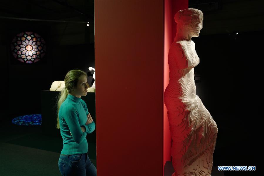 A visitor views an art piece made with LEGO bricks by artist Nathan Sawaya during an exhibition in Moscow, Russia, on Feb. 28, 2017. 