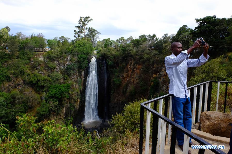 A man takes a selfie in front of Thomson's falls in Nyahururu, 186 kilometers north of Kenya's capital Nairobi Feb. 28, 2017. The waterfall on a ledge of volcanic rock, discovered by Scottish geologist and naturalist Joseph Thomson in 1883, is a major economic resource for the adjacent town of Nyahururu.
