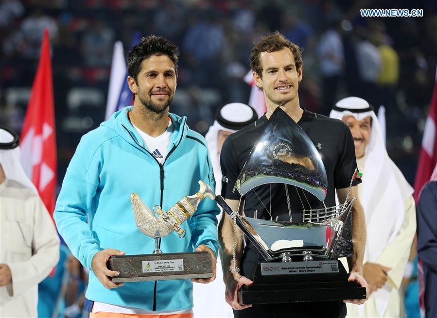 Andy Murray (R) of Britain and Fernando Verdasco of Spain pose with the trophy after their men's singles final match at the Dubai Duty Free Tennis ATP Championships in Dubai, the United Arab Emirates, March 4, 2017. 