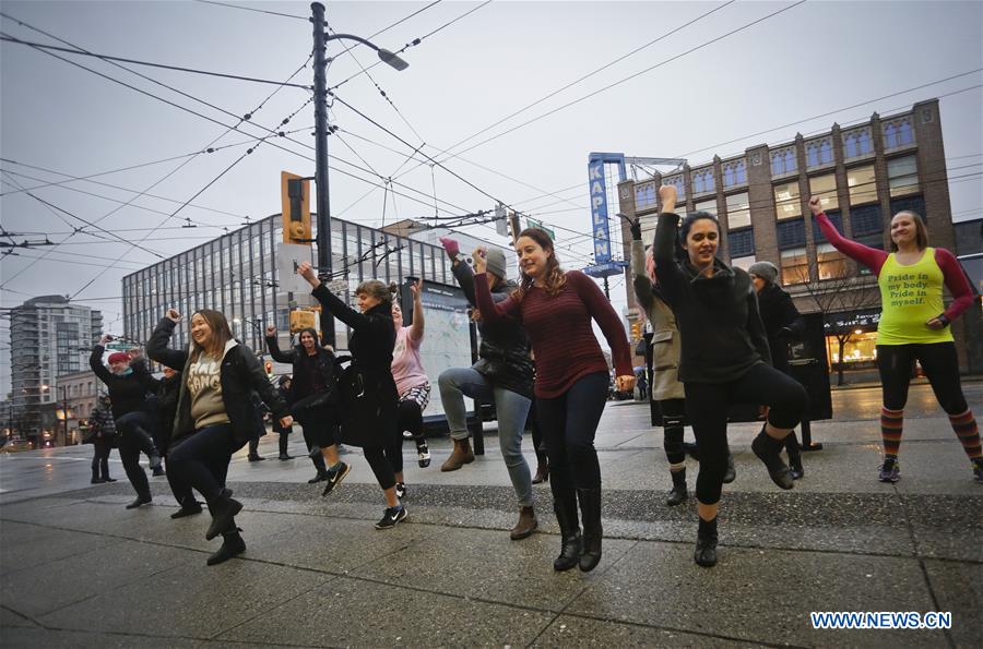 Women participate in a flash mob dance to celebrate the International Women's Day in Vancouver, Canada, March 7, 2017. 