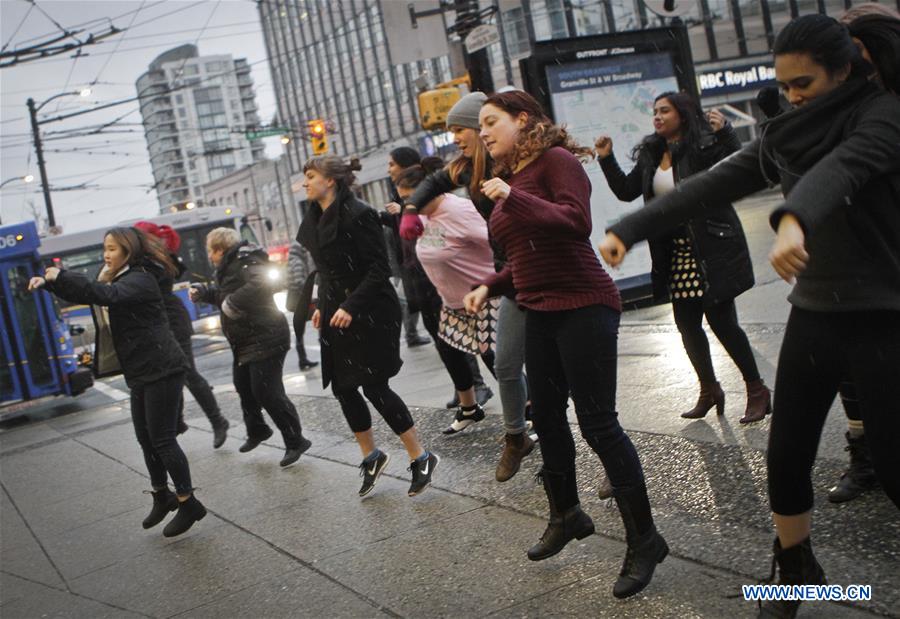 Women participate in a flash mob dance to celebrate the International Women's Day in Vancouver, Canada, March 7, 2017. 