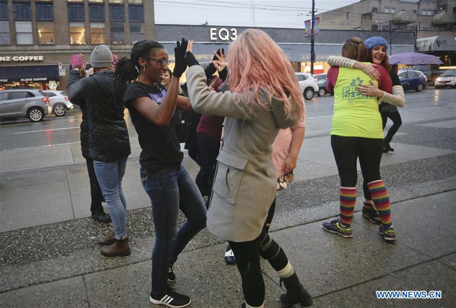 Women participate in a flash mob dance to celebrate the International Women's Day in Vancouver, Canada, March 7, 2017. 