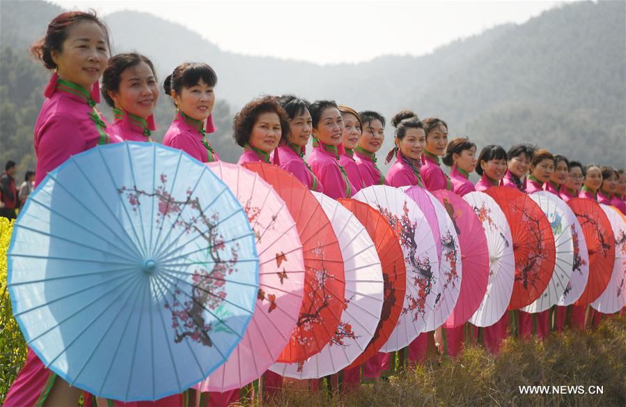 Women present Qipao, a traditional Chinese dress, during a Qipao show at a cole flower field in Nanchang, capital of east China's Jiangxi Province, March 8, 2017. (Xinhua/Wan Xiang)  