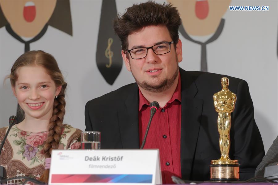 Hungarian film director Kristof Deak (R) attends a press conference of film 'Sing' in Budapest, Hungary, March 8, 2017. 
