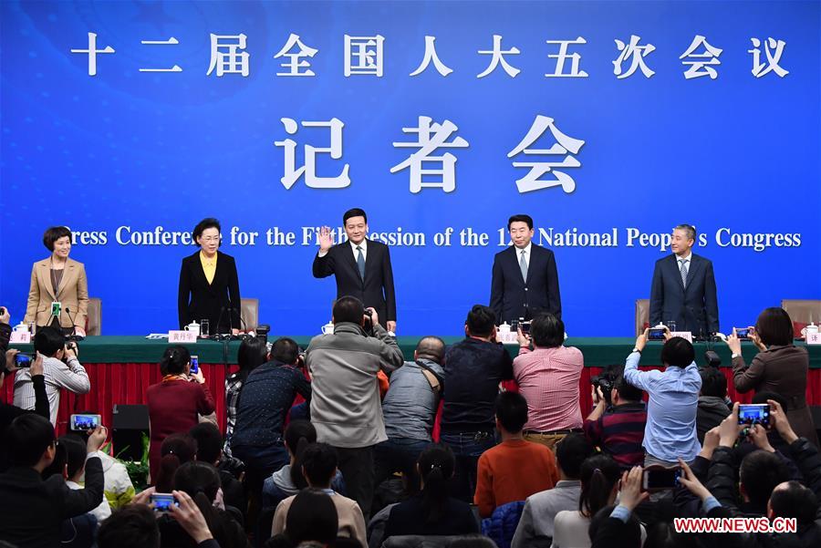 Xiao Yaqing, head of State-owned Assets Supervision and Administration Commission (SASAC), Zhang Xiwu and Huang Danhua, deputy heads of the SASAC, and Peng Huagang, deputy secretary and spokesperson of the SASAC, greet journalists at a press conference on reform of state-owned enterprises for the fifth session of the 12th National People's Congress (NPC) in Beijing, capital of China, March 9, 2017. (Xinhua/Li Xin)