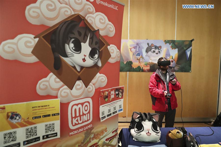 A visitor plays a cat-themed game during the Cat Camp in New York, the United States, on March 11, 2017.