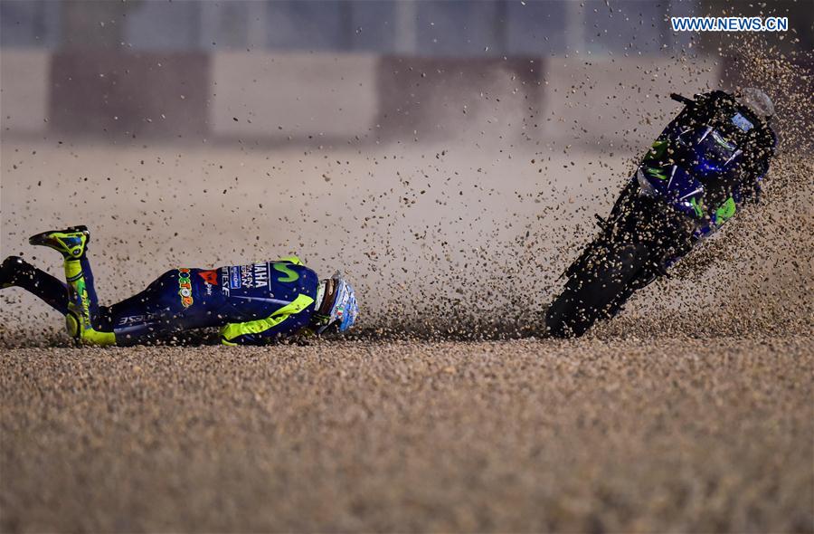 Italian rider Valentino Rossi of Movistar Yamaha MotoGP is thrown from his bike as he crashes out during the pre-season test at the Losail International Circuit in Qatar's capital Doha on March 11, 2017, ahead of Grand Prix of Qatar which will be held from March 23 to 26.