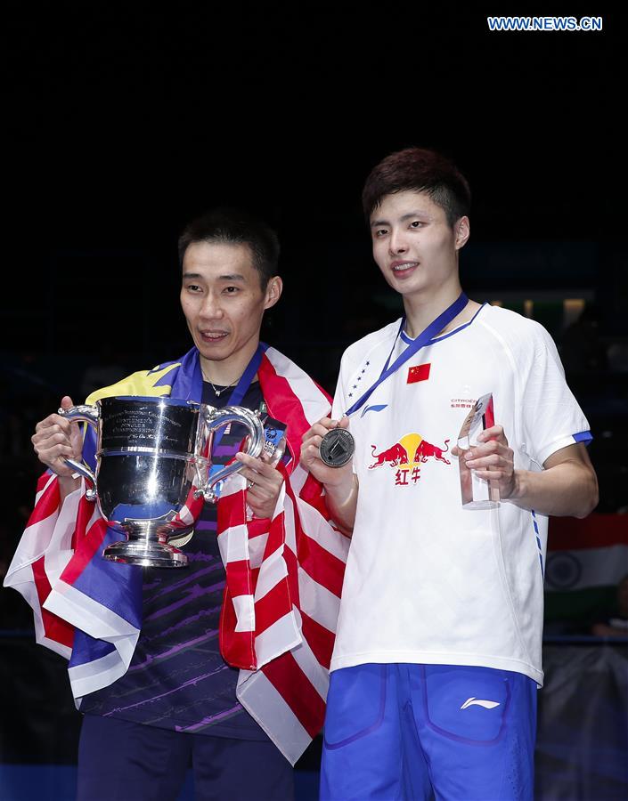 Lee Chong Wei(L) of Malaysia poses with Shi Yuqi of China during the awarding ceremony after men's singles final at All England Open Badminton Championships 2017 in Birmingham, Britain on March 12, 2017.