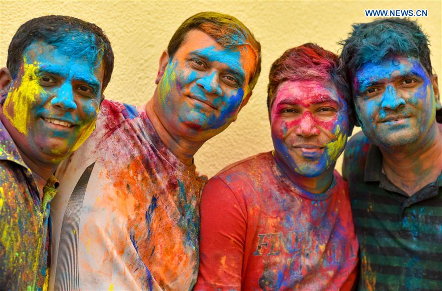 Men of Indian community in Qatar are covered in colored powder during celebrations of the Holi, the Indian festival of Colors, in Doha, capital of Qatar, on March 13, 2017. 