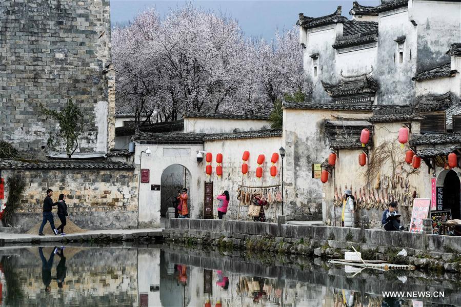 Tourists visit Yuezhao, or Moon Pool, at Hongcun, an ancient village in Yixian County of Huangshan City, east China's Anhui Province, March 15, 2017. 