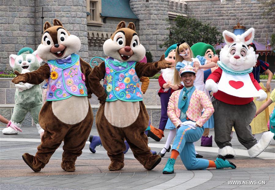 Classic Disney characters walk out of Hong Kong Disneyland before a Springtime Carnival which will kick off Thursday in Hong Kong, south China, March 15, 2017. 