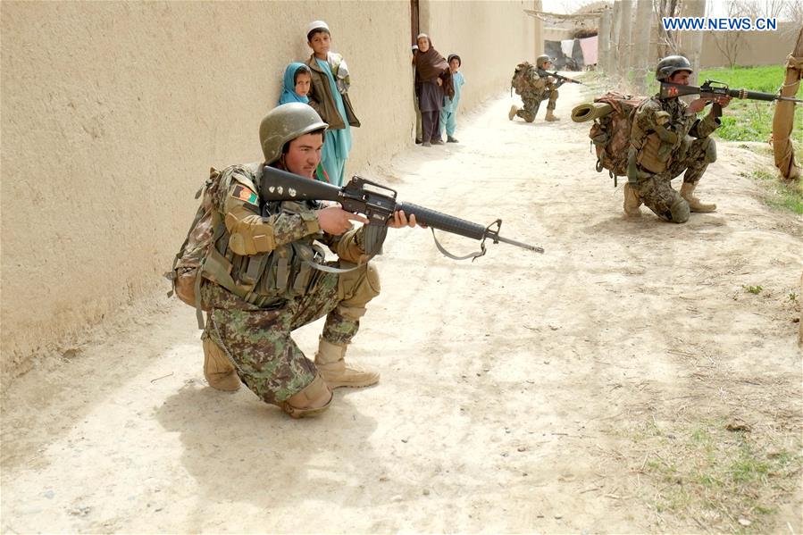 Afghan army soldiers take positions during a military operation in southern Kandahar province of Afghanistan, on March, 14, 2017.