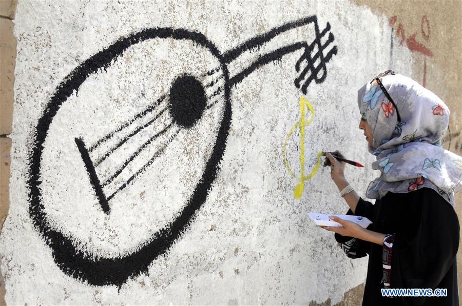 A woman paints graffiti on a wall during a campaign in Sanaa, Yemen, on March 15, 2017. A campaign was staged for people to express their wishes for peace and rejection of violence and war by painting graffiti on the walls of Sanaa's streets here on Wednesday. (Xinhua/Mohammed Mohammed) A woman paints graffiti on a wall during a campaign in Sanaa, Yemen, on March 15, 2017. A campaign was staged for people to express their wishes for peace and rejection of violence and war by painting graffiti on the walls of Sanaa's streets here on Wednesday. (Xinhua/Mohammed Mohammed)