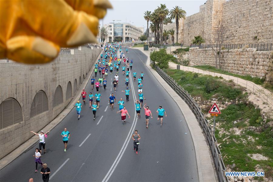 Runners take part in the 7th International Jerusalem Winner Marathon in Jerusalem, on March 17, 2017. (Xinhua/Guo Yu)