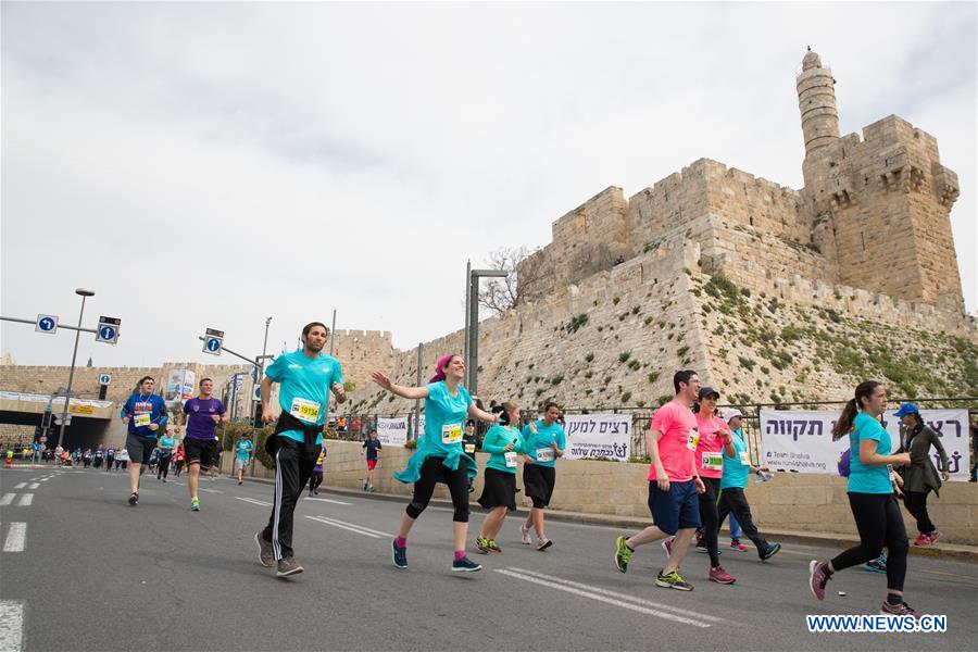 Runners take part in the 7th International Jerusalem Winner Marathon in Jerusalem, on March 17, 2017. (Xinhua/Guo Yu)