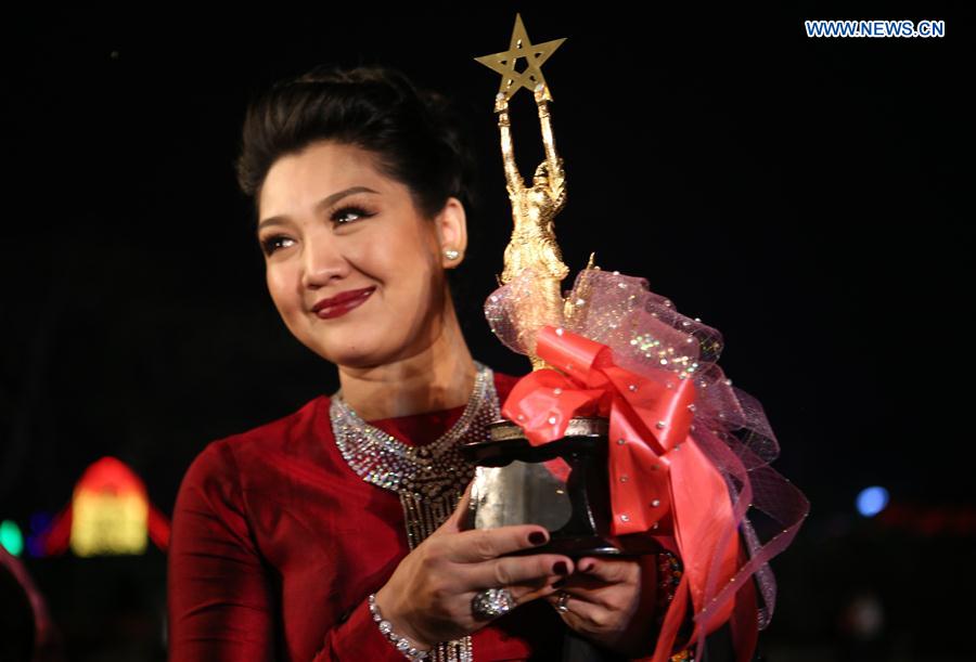 The best actress winner Thet Mon Myint poses for photos during the Myanmar Academy Awarding ceremony organized by Myanmar Motion Pictures Organization in Yangon, Myanmar, March 18, 2017. 