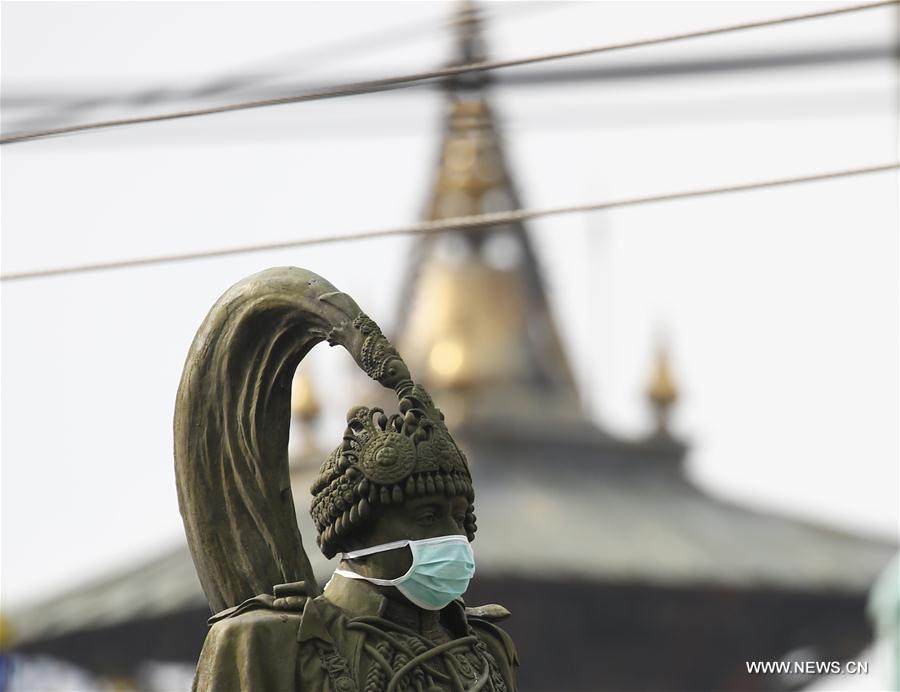 Due to more air pollution in Kathmandu, youth groups protest symbolically by keeping mask in the statue. (Xinhua/Pratap Thapa) 