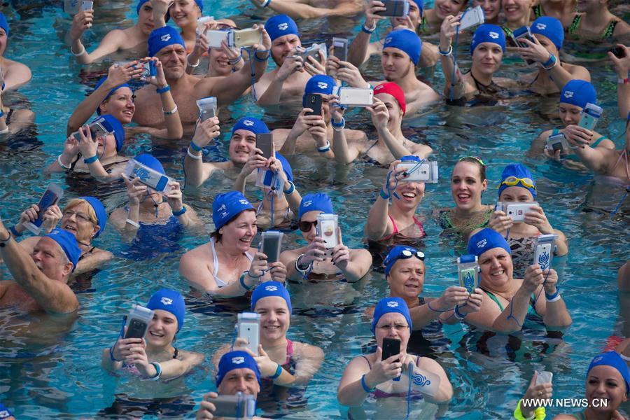 A total of 113 people take selfies in a swimming pool at Szechenyi Thermal Bath to break Hungarian record before the World Water Day in Budapest, Hungary on March 19, 2017. (Xinhua/Attila Volgyi) 