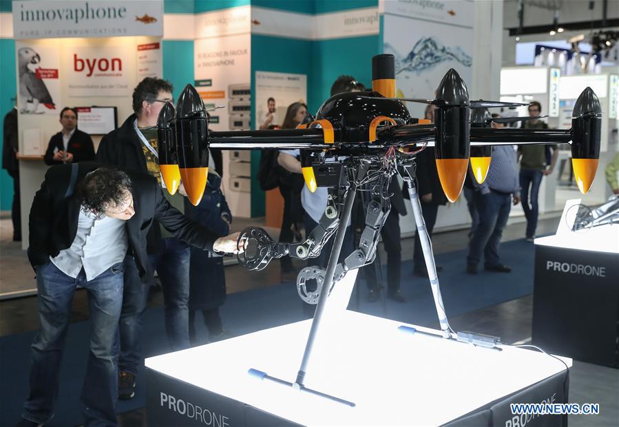 A visitor inspects a drone displayed at the ProDrone booth during the CeBIT 2017 in Hanover, Germany, on March 20, 2017. The world's leading trade fair showcasing IT and communications products and solutions CeBIT 2017 kicked off on Monday and will last until March 24. The show with the theme 'd!conomy - no limits' this year attracted around 3,000 exhibitors from 70 countries and regions and is expected to attract some 200,000 visitors. (Xinhua/Shan Yuqi) 