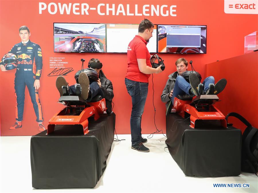 Visitors experience race car driving via VR technology at the Exact booth during the CeBIT 2017 in Hanover, Germany, on March 20, 2017. The world's leading trade fair showcasing IT and communications products and solutions CeBIT 2017 kicked off on Monday and will last until March 24. The show with the theme 'd!conomy - no limits' this year attracted around 3,000 exhibitors from 70 countries and regions and is expected to attract some 200,000 visitors. (Xinhua/Shan Yuqi) Visitors experience race car driving via VR technology at the Exact booth during the CeBIT 2017 in Hanover, Germany, on March 20, 2017. The world's leading trade fair showcasing IT and communications products and solutions CeBIT 2017 kicked off on Monday and will last until March 24. The show with the theme 'd!conomy - no limits' this year attracted around 3,000 exhibitors from 70 countries and regions and is expected to attract some 200,000 visitors. (Xinhua/Shan Yuqi)
