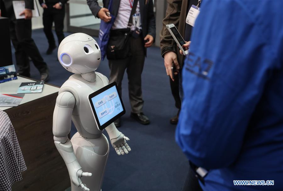 Photo taken on March 20, 2017 shows a robot displayed at a booth during the CeBIT 2017 in Hanover, Germany. The world's leading trade fair showcasing IT and communications products and solutions CeBIT 2017 kicked off on Monday and will last until March 24. The show with the theme 'd!conomy - no limits' this year attracted around 3,000 exhibitors from 70 countries and regions and is expected to attract some 200,000 visitors. (Xinhua/Shan Yuqi)
