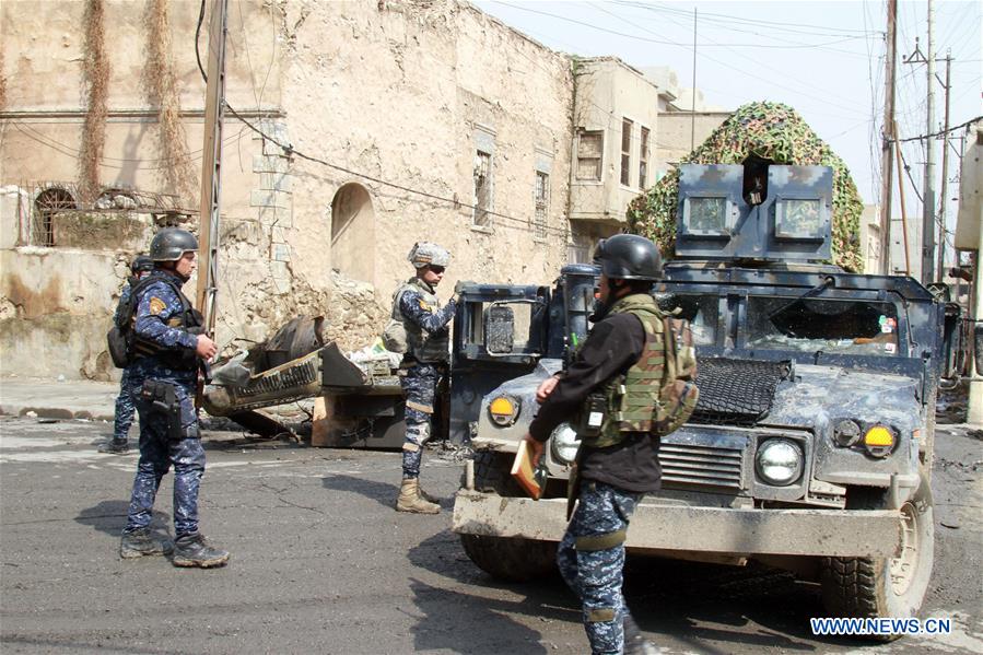 Iraqi federal police forces patrol the street in Alkulat area, western Mosul, Iraq, on March 20, 2017. As Iraqi forces gained more territories in western Mosul, the federal police strengthened their control on the newly-liberated areas and began clearing the improvised explosive devices left by Islamic State group. (Xinhua/Yaser Jawad) 