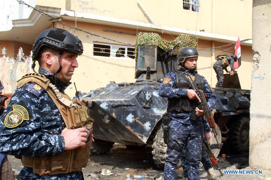 Iraqi federal police forces patrol the street in Alkulat area, western Mosul, Iraq, on March 20, 2017. As Iraqi forces gained more territories in western Mosul, the federal police strengthened their control on the newly-liberated areas and began clearing the improvised explosive devices left by Islamic State group. (Xinhua/Yaser Jawad) 