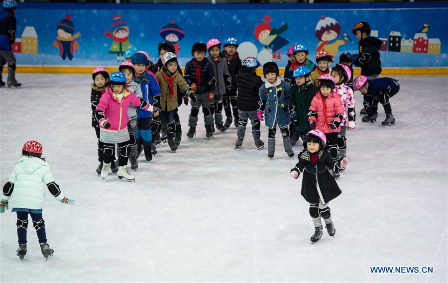 Pupils take a skating class in the ice rink located in Nanjing Olympic Center in Nanjing, capital of east China's Jiangsu province, March 7, 2017. With more and more people from south and west China participating in winter sports, the popularity of winter sports in east China's Jiangsu province began to grow fast. In recent years, 13 ice rinks using social capital have been opened in Jiangsu. The operators of these ice rinks established clubs to attract more than 100,000 people to practice skating. The Century Star Rink located in Nanjing Olympic Center is the biggest indoor ice rink in Nanjing. The club only had dozens of members in 2008, but now it has more than 20,000 members. At the mean time, the club cooperates with 8 elementary schools in neighborhood to open classes teaching skating skills. About 10,000 pupils learned the basic skills of skating and 4 ice hockey squads were founded in last 9 years. A total of 15 small outdoor ski resorts have also been set up in northern Jiangsu province. During the last snow season, which is only two months due to warm weather here, these ski resorts accommodated around 10,000 person-times of visitors. (Xinhua/Li Xiang)