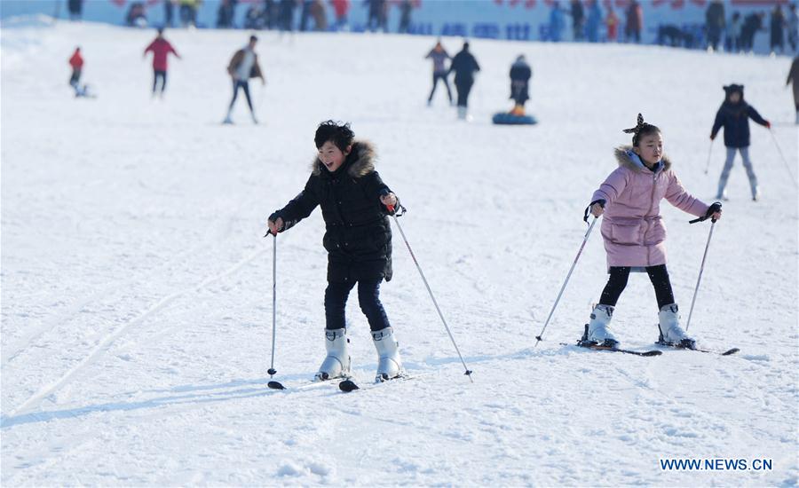 Children enjoy skiing in a ski resort located in Dajingshan mountain in Xuzhou, east China's Jiangsu province, Feb. 11, 2017. With more and more people from south and west China participating in winter sports, the popularity of winter sports in east China's Jiangsu province began to grow fast. In recent years, 13 ice rinks using social capital have been opened in Jiangsu. The operators of these ice rinks established clubs to attract more than 100,000 people to practice skating. The Century Star Rink located in Nanjing Olympic Center is the biggest indoor ice rink in Nanjing. The club only had dozens of members in 2008, but now it has more than 20,000 members. At the mean time, the club cooperates with 8 elementary schools in neighborhood to open classes teaching skating skills. About 10,000 pupils learned the basic skills of skating and 4 ice hockey squads were founded in last 9 years. A total of 15 small outdoor ski resorts have also been set up in northern Jiangsu province. During the last snow season, which is only two months due to warm weather here, these ski resorts accommodated around 10,000 person-times of visitors. (Xinhua/Sun Jingxian)