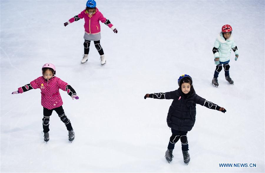 Pupils take a skating class in the ice rink located in Nanjing Olympic Center in Nanjing, capital of east China's Jiangsu province, March 7, 2017. With more and more people from south and west China participating in winter sports, the popularity of winter sports in east China's Jiangsu province began to grow fast. In recent years, 13 ice rinks using social capital have been opened in Jiangsu. The operators of these ice rinks established clubs to attract more than 100,000 people to practice skating. The Century Star Rink located in Nanjing Olympic Center is the biggest indoor ice rink in Nanjing. The club only had dozens of members in 2008, but now it has more than 20,000 members. At the mean time, the club cooperates with 8 elementary schools in neighborhood to open classes teaching skating skills. About 10,000 pupils learned the basic skills of skating and 4 ice hockey squads were founded in last 9 years. A total of 15 small outdoor ski resorts have also been set up in northern Jiangsu province. During the last snow season, which is only two months due to warm weather here, these ski resorts accommodated around 10,000 person-times of visitors. (Xinhua/Li Xiang)