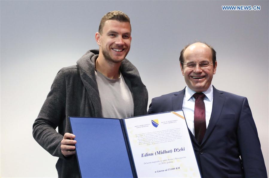 The captain of the football team of Bosnia and Herzegovina (BiH) and AS Roma's striker Edin Dzeko (L) and the Minister of Civil Affairs of BiH Adil Osmanovic pose for a photo in Sarajevo, BiH, March 24, 2017. 