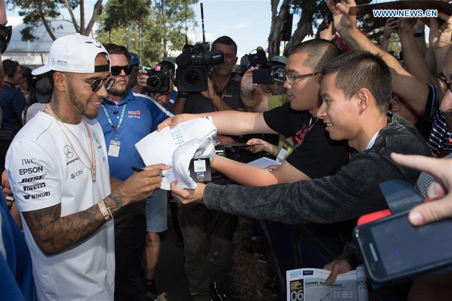 Mercedes AMG Petronas Formula One driver Lewis Hamilton(L) of Britain signs autographs for his fans as he arrives for the third practice session ahead of the Australian Formula One Grand Prix at Albert Park circuit in Melbourne, Australia on March 25, 2017. Mercedes AMG Petronas Formula One driver Lewis Hamilton(L) of Britain signs autographs for his fans as he arrives for the third practice session ahead of the Australian Formula One Grand Prix at Albert Park circuit in Melbourne, Australia on March 25, 2017.