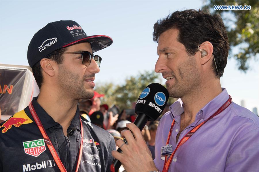 Red Bull Racing Formula One driver Daniel Ricciardo(L) of Australia is interviewed by former Australian formula one driver Mark Webber as he arrives for the third practice session ahead of the Australian Formula One Grand Prix at Albert Park circuit in Melbourne, Australia on March 25, 2017. 