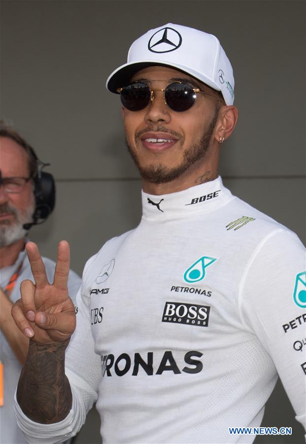 Mercedes AMG Petronas Formula One driver Lewis Hamilton of Britain celebrates after winning the qualifying session of the Australian Formula One Grand Prix at Albert Park circuit in Melbourne, Australia on March 25, 2017. Lewis Hamilton will start from the pole position. The Australian Formula One Grand Prix will take place in Melbourne on March 26. (Xinhua/Bai Xue) 