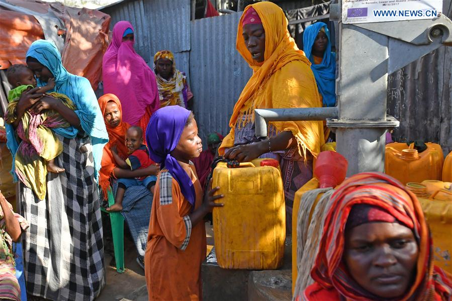 A girl fetches water at an Internal Displaced Person (IDP) camp in Mogadishu, capital of Somalia, on March 22, 2017.