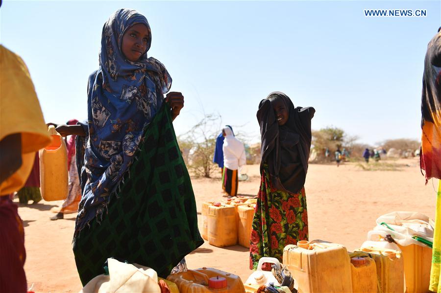 Girls wait in line to get water at an Internal Displaced Person (IDP) camp in Doolow, a border town with Ethiopia, Somalia, on March 19, 2017. Girls wait in line to get water at an Internal Displaced Person (IDP) camp in Doolow, a border town with Ethiopia, Somalia, on March 19, 2017.