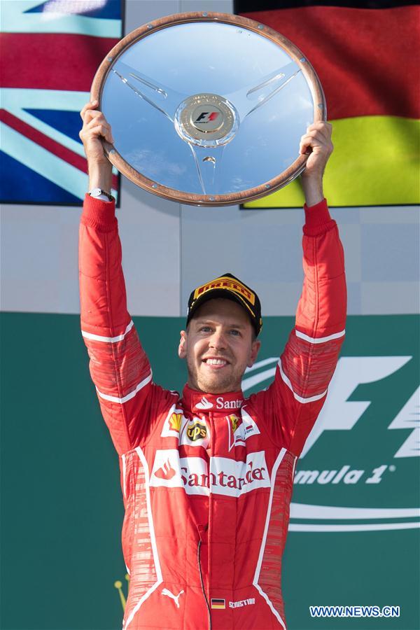 Scuderia Ferrari's German driver Sebastian Vettel celebrates during the awarding ceremony for the Australian Formula One Grand Prix at Albert Park circuit in Melbourne, Australia on March 26, 2017. 