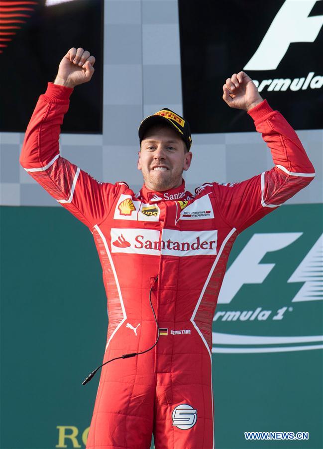 Scuderia Ferrari's German driver Sebastian Vettel celebrates during the awarding ceremony for the Australian Formula One Grand Prix at Albert Park circuit in Melbourne, Australia on March 26, 2017.
