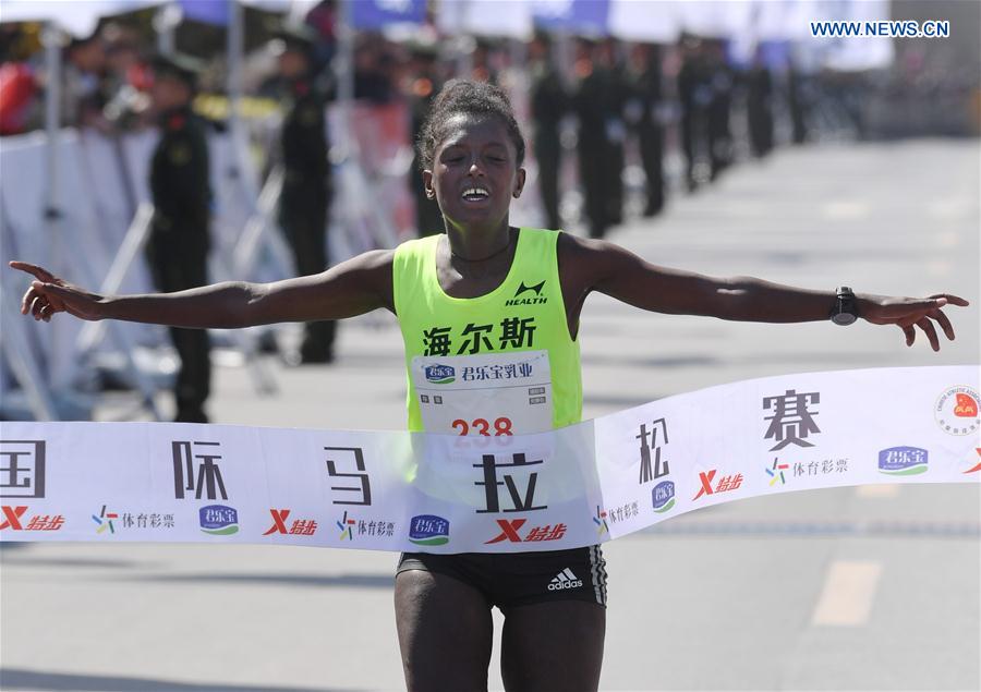 Gebeyahu Tigist Memuye from Ethiopia crosses the finish line during the Zhengkai International Marathon in Kaifeng, city of central China's Henan Province on March 26, 2017. 