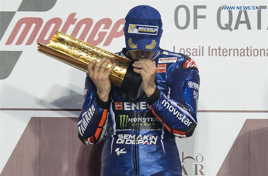 Movistar Yamaha MotoGP's Spanish rider Maverick Vinales kisses the trophy during the awarding ceremony for the 2017 FIM MotoGP Grand Prix of Qatar at the Losail International Circuit in Doha, capital of Qatar, on March 26, 2017. Movistar Yamaha MotoGP's Spanish rider Maverick Vinales kisses the trophy during the awarding ceremony for the 2017 FIM MotoGP Grand Prix of Qatar at the Losail International Circuit in Doha, capital of Qatar, on March 26, 2017.